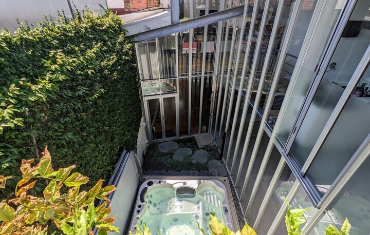 Atrium with a spa and outdoor shower